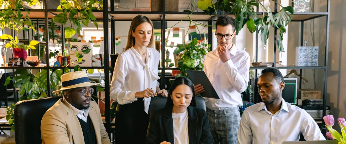 Diverse editorial team reviewing OppLoans data — independent consumer guide