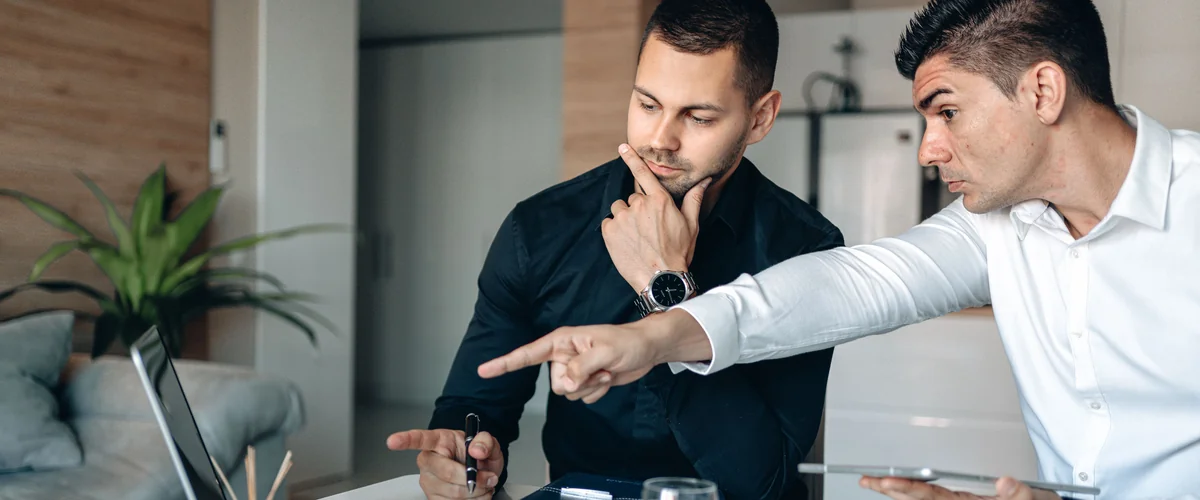 Financial advisors comparing OppLoans personal loan options on laptop